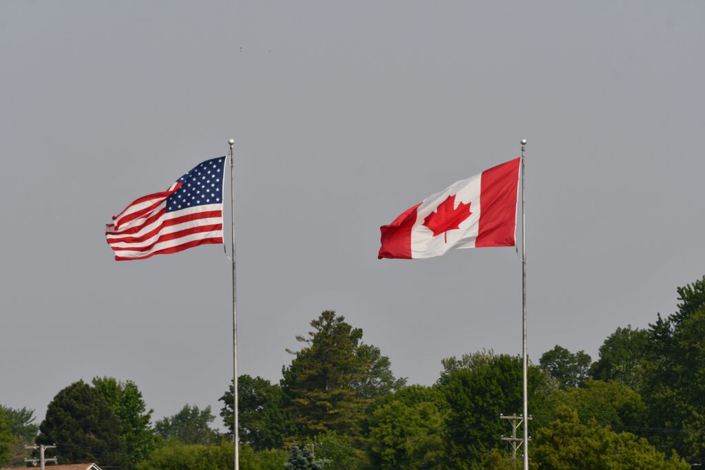 United States and Canadian flags flying side by side.